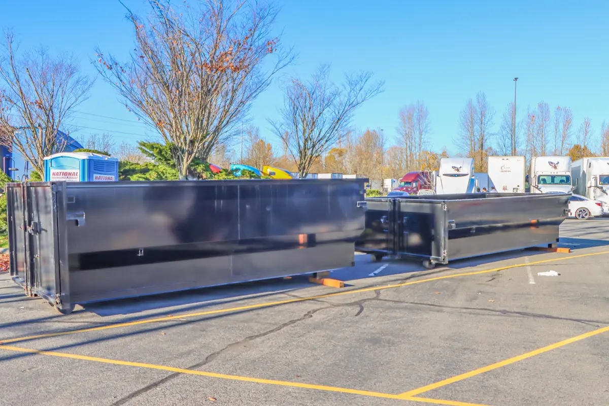 Professional dumpster rental service with roll-off container on residential driveway in Folsom